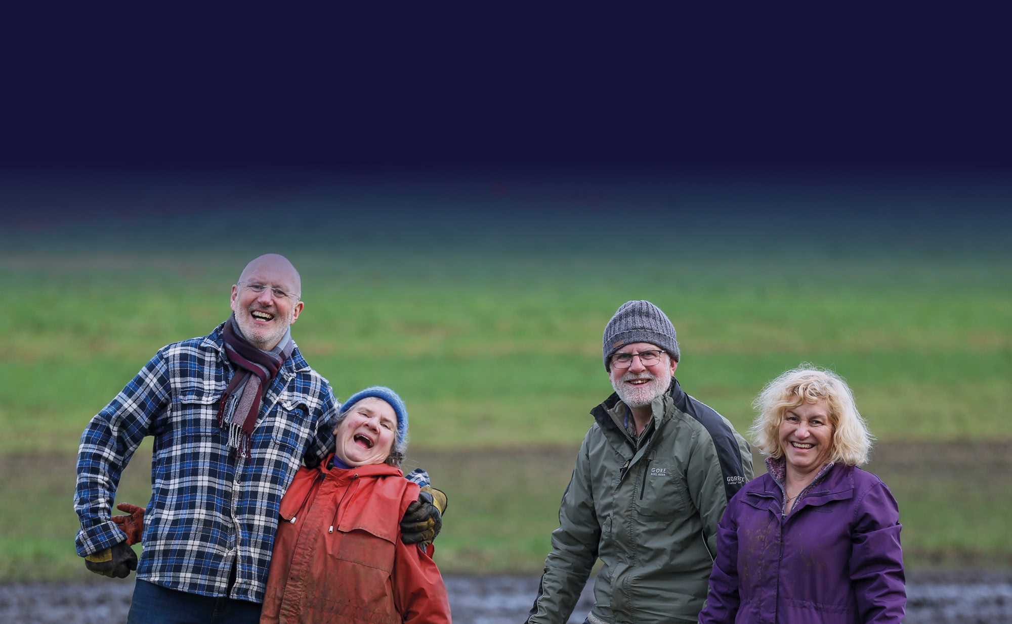 two elderly couples laughing to the camera