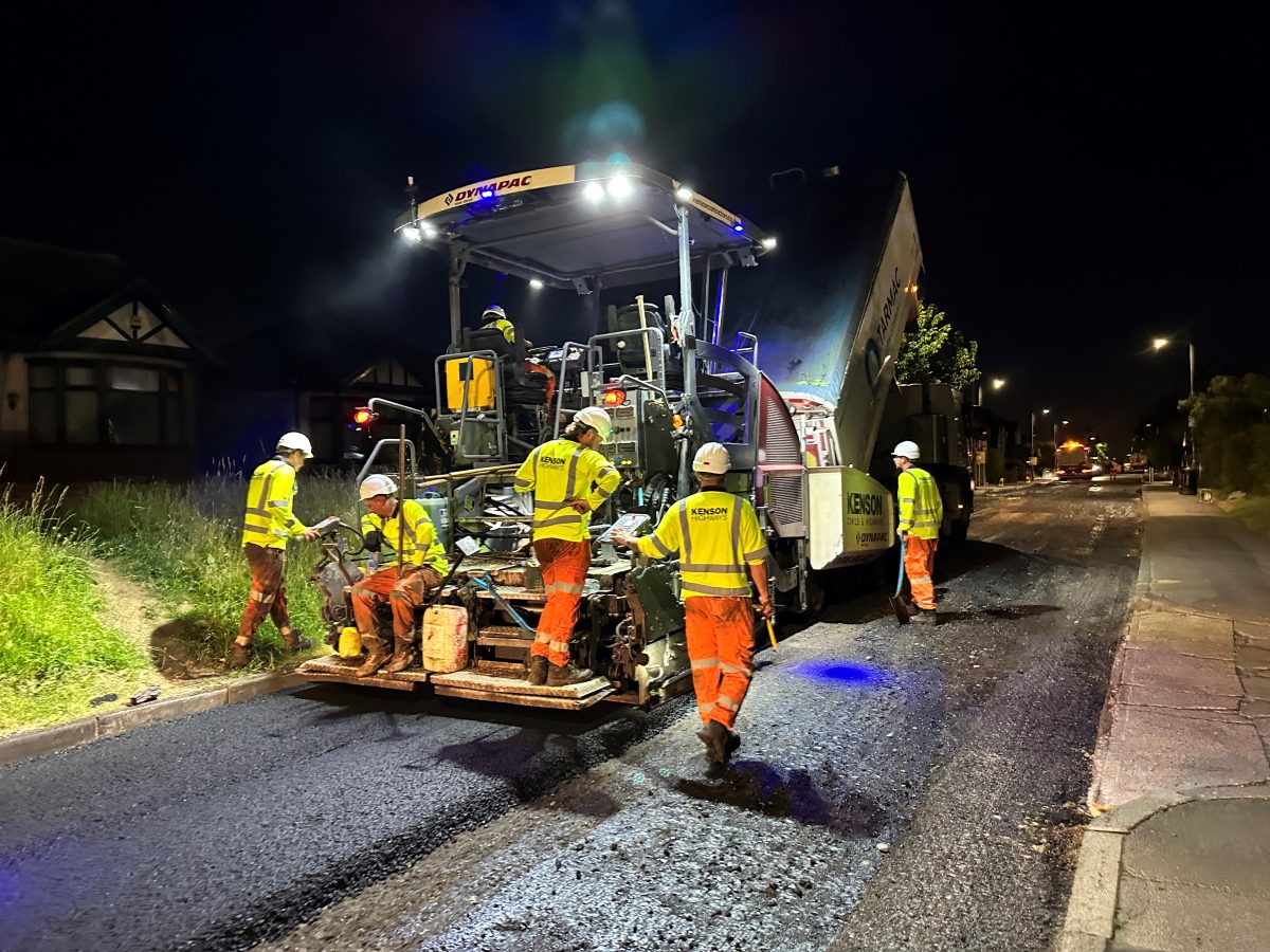 Asphalt being laid on road at night